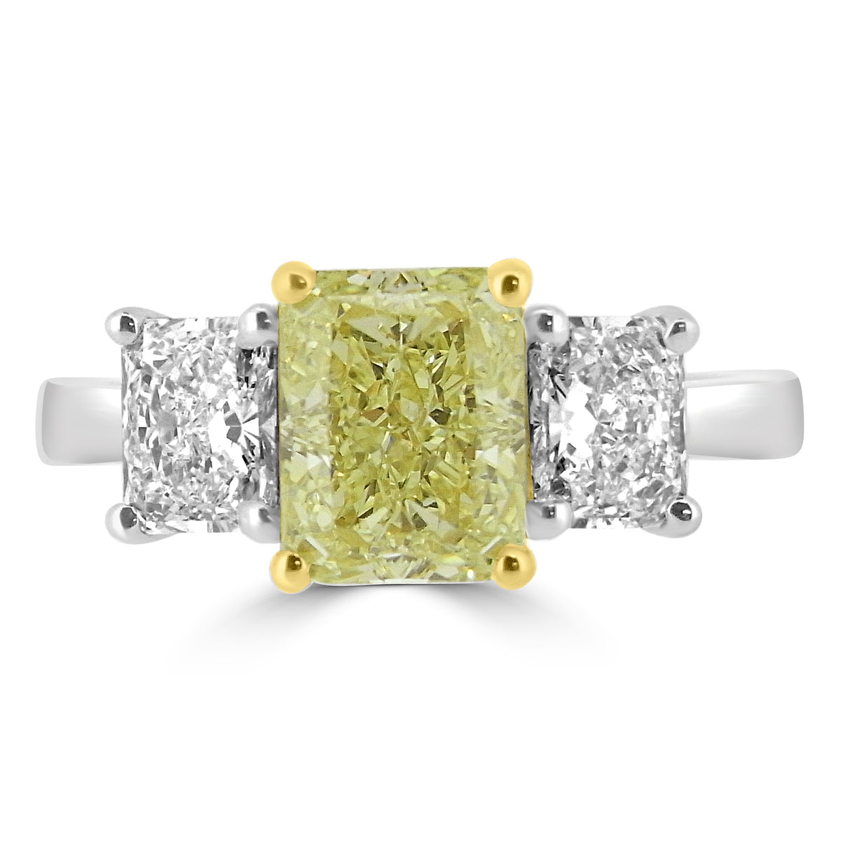 Radiant cut natural fancy yellow diamond three stone ring with white radiant diamond sides in platinum and yellow gold claws