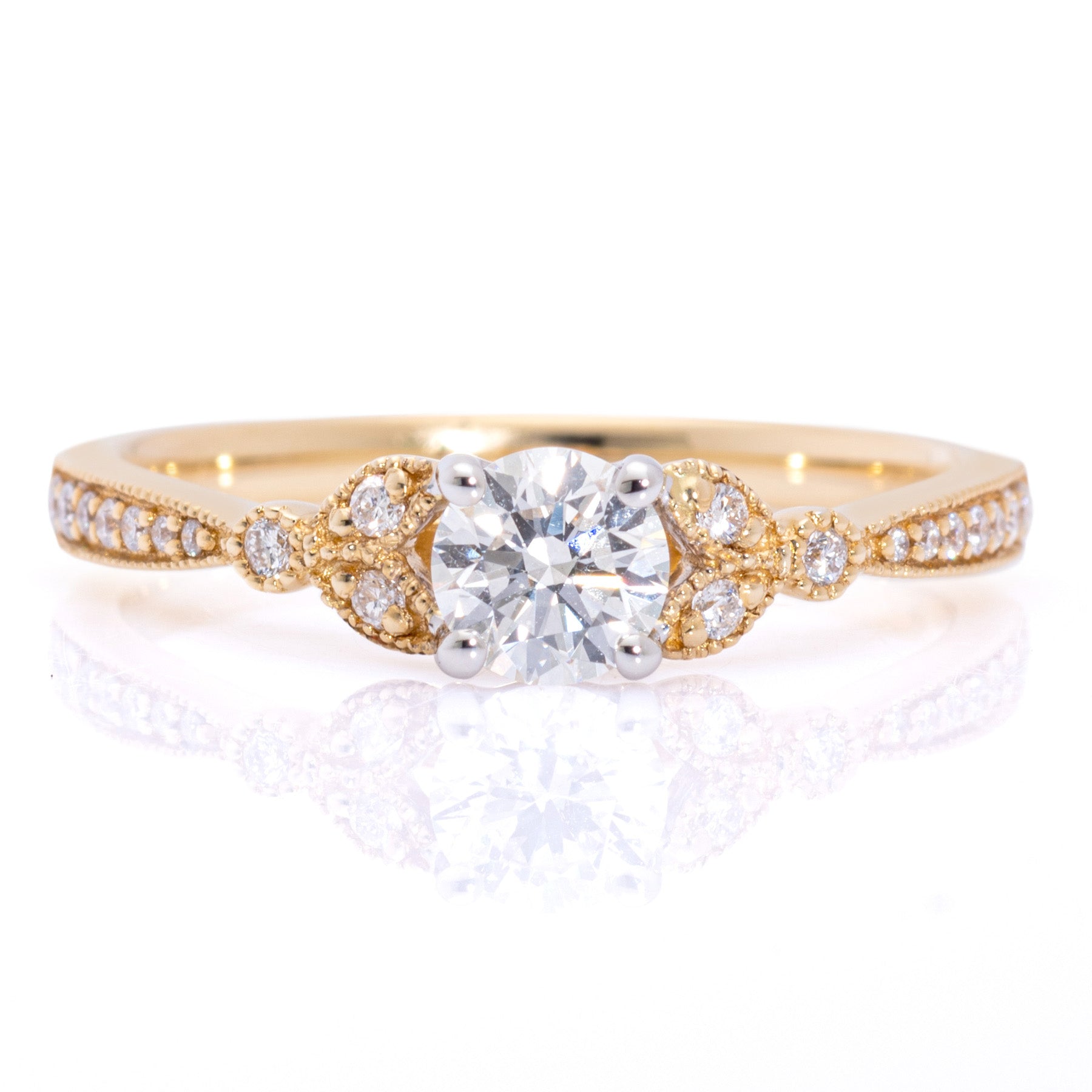 Round brilliant diamond millegraine leaf setting round brilliant diamonds diamond set shoulders yellow gold harrogate jewellers fogal and barnes