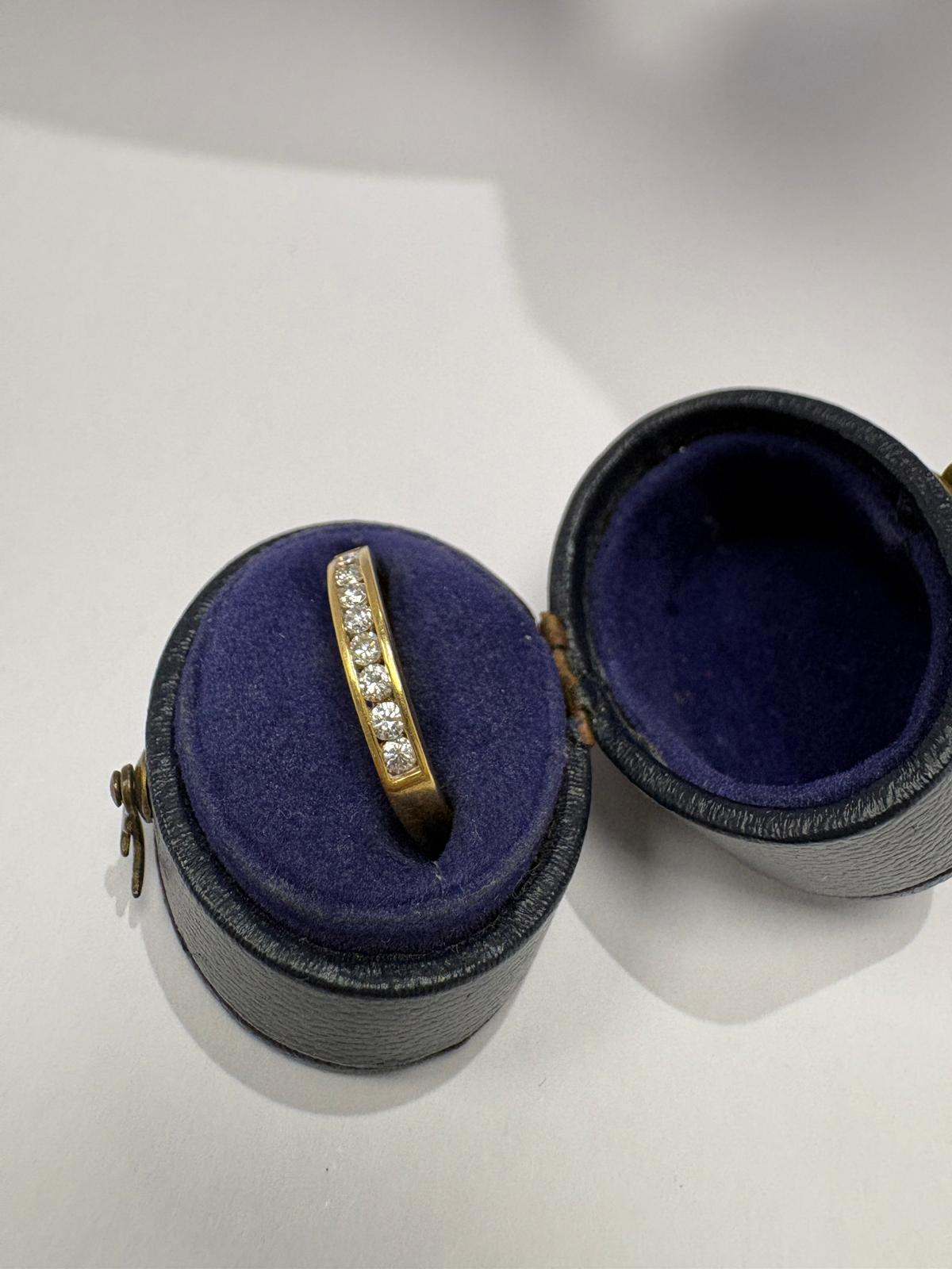 Profile view of pre-loved 18ct gold channel-set diamond band ring, size M