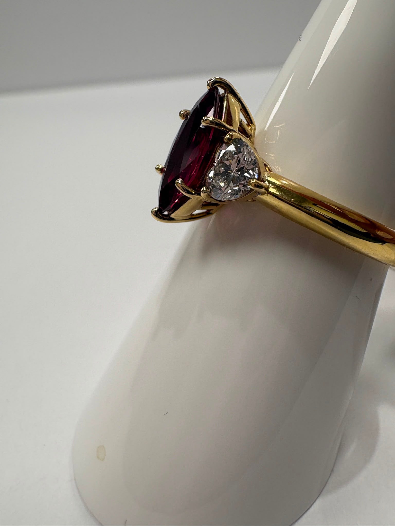 pre-loved ruby ring, second hand 18ct gold ring UK, GIA certified ruby ring, three stone ruby diamond ring, marquise ruby ring, pre-owned fine jewellery UK, heart diamond ring, second hand fine jewellery UK, certified ruby engagement ring