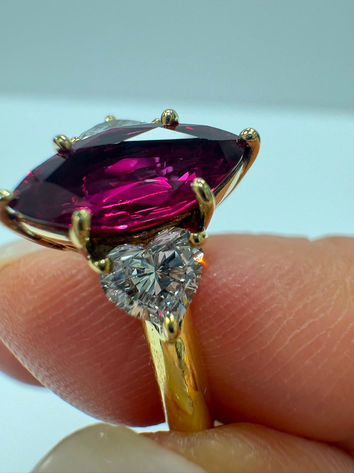 pre-loved ruby ring, second hand 18ct gold ring UK, GIA certified ruby ring, three stone ruby diamond ring, marquise ruby ring, pre-owned fine jewellery UK, heart diamond ring, second hand fine jewellery UK, certified ruby engagement ring