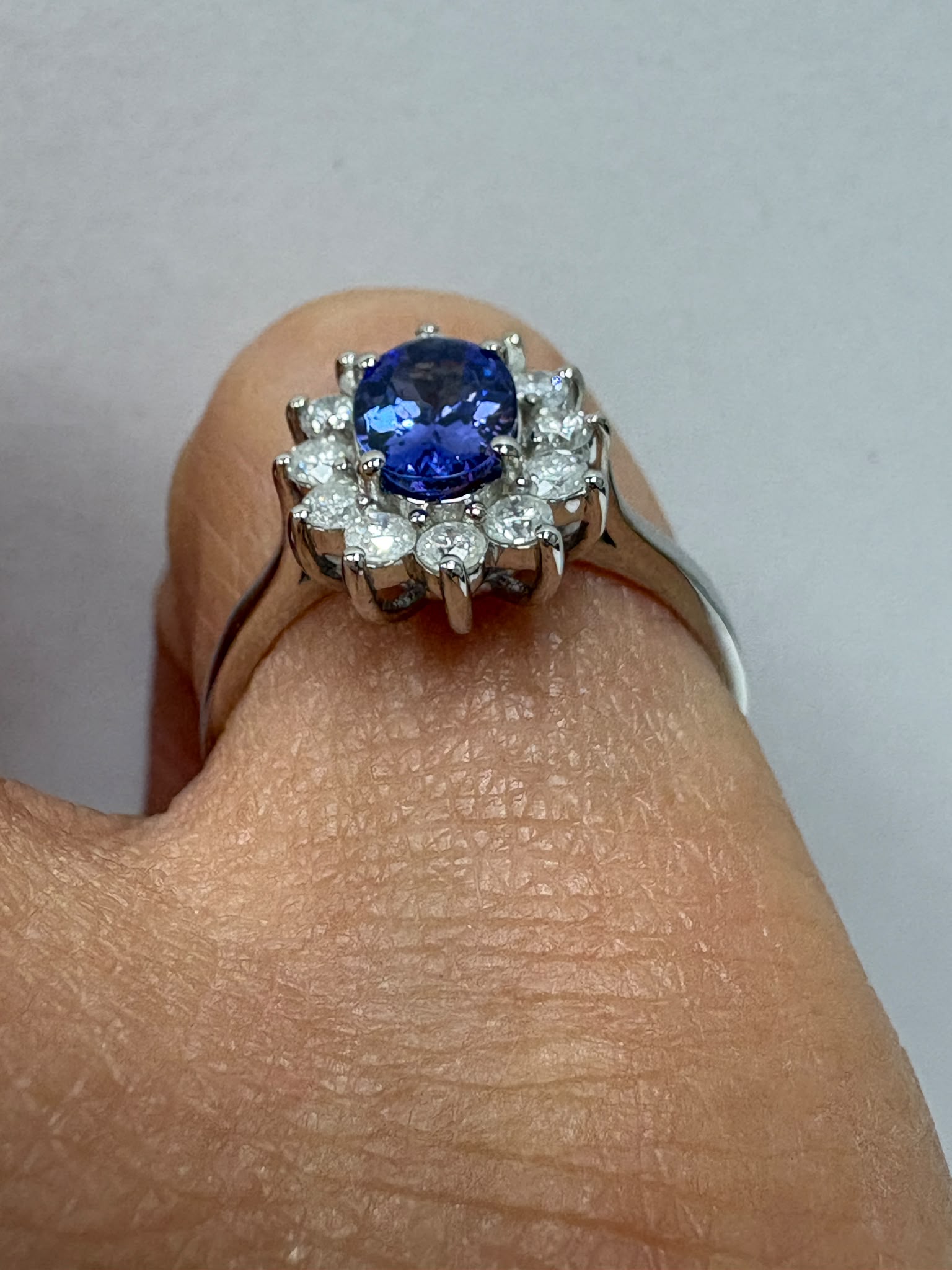 genuine pre-loved tanzanite and diamond cluster ring in 9ct white gold. 0.81ct tanzanite, 0.42ct diamonds, size M. Visit our Harrogate showroom today.