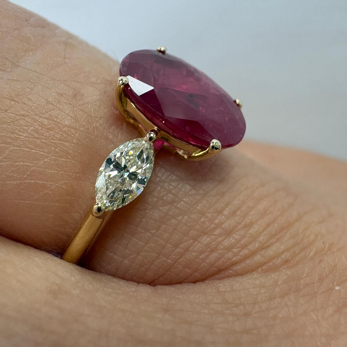 ruby and diamond ring, 3 carat ruby ring, oval ruby ring UK, marquise diamond ring, east west marquise ring, ruby engagement ring, ruby anniversary ring, 18ct gold ruby ring