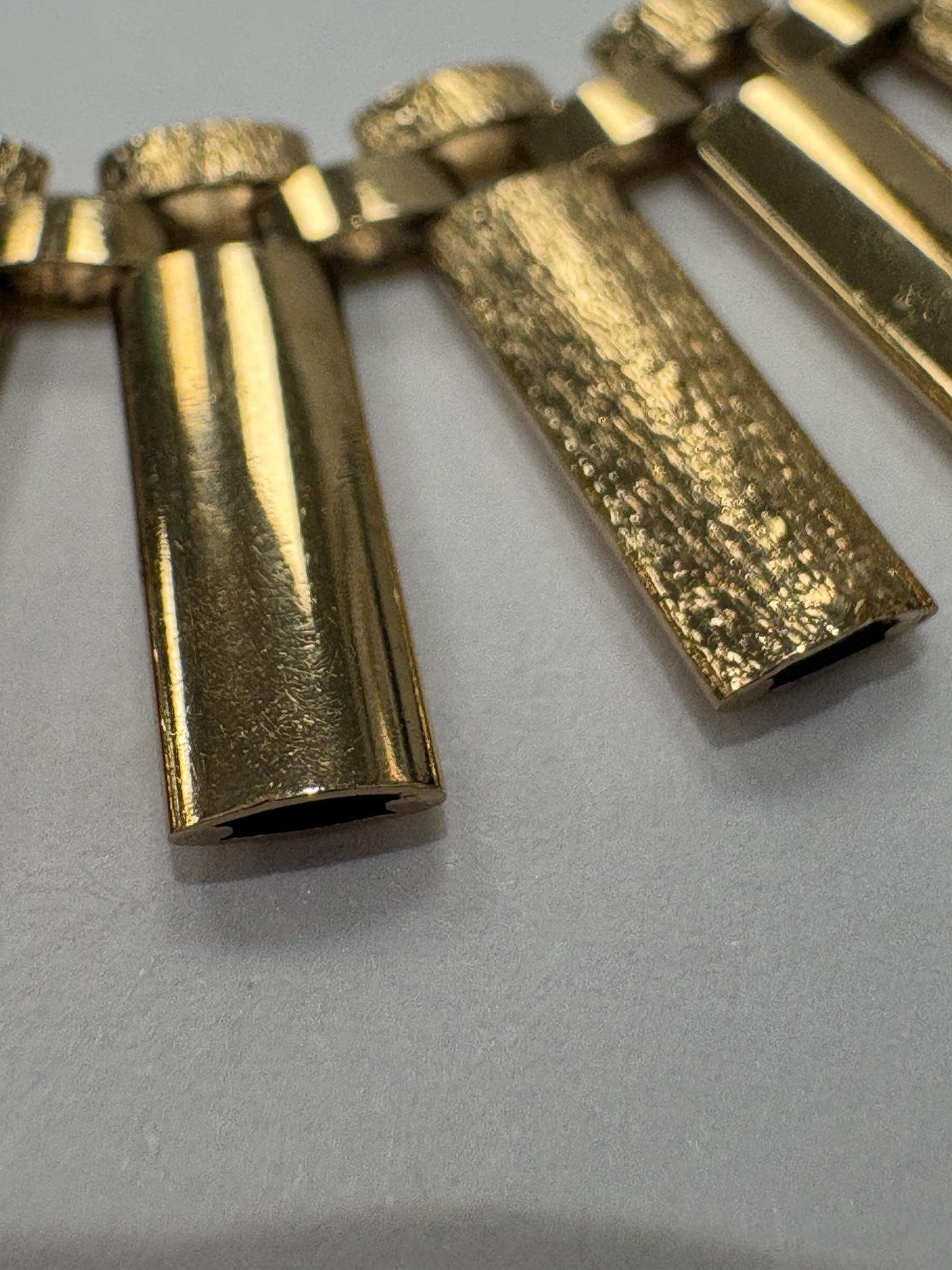 Vintage 1970s 9ct yellow gold graduating fringe necklace with alternating textured and polished cylindrical bars on a brick link chain with safety clasp, 20.50g, shown on white background, available at Fogal & Barnes Harrogate