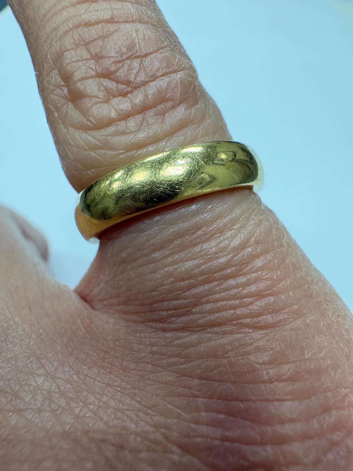 Profile view of pre-loved 18ct yellow gold wide court wedding band, size J