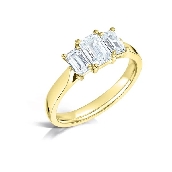 Emerald cut diamond center with 2 diamond emerald on the sides set on 18k yellow gold from fogal and barnes fine jewellers of harrogate