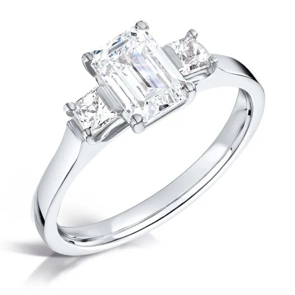 Emerald cut diamond and aquare diamond three stone engagement ring set on 18k white gold from fogal and barnes fine jewellers of Harrogate