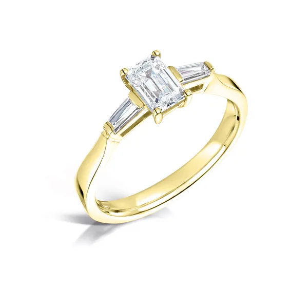 Emerald cut 1.00ct diamond center with 2 tapered baguettes set on 18k yellow gold from fogal and barnes fine jewellers of harrogate. Three stone diamond engagement ring