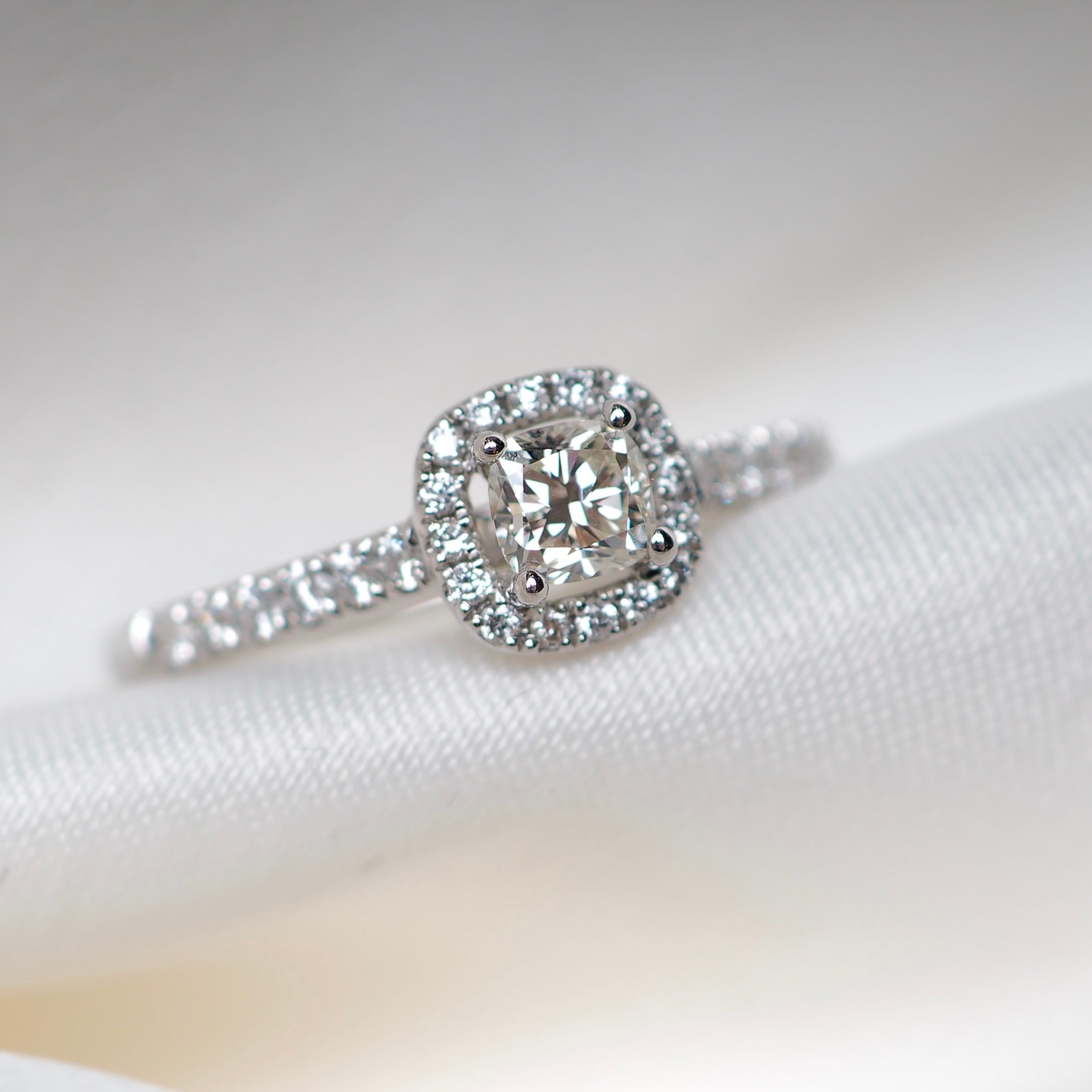Cushion cut diamond ring halo white gold diamond set shoulders Harrogate jewellers Fogal and barnes