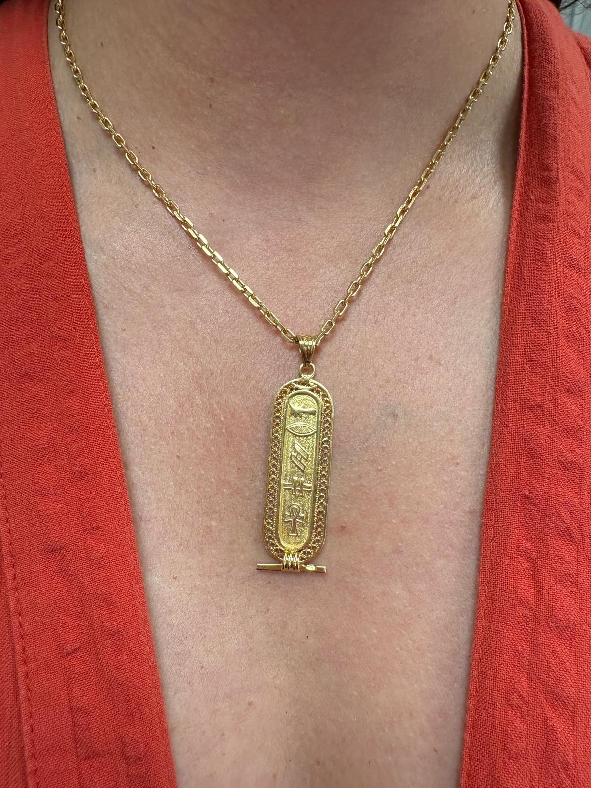 Vintage Egyptian 18ct yellow gold cartouche pendant with hieroglyphic engravings including ankh symbol and intricate filigree border, 3.96g, shown front and back and worn on neck, available at Fogal & Barnes Harrogate