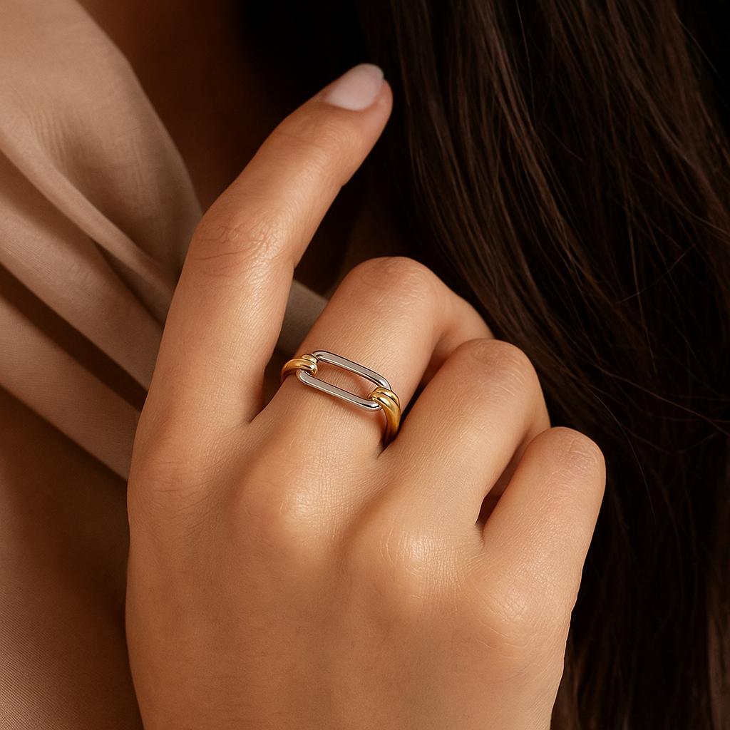 Close-up of a hand wearing a gold ring on a dark background