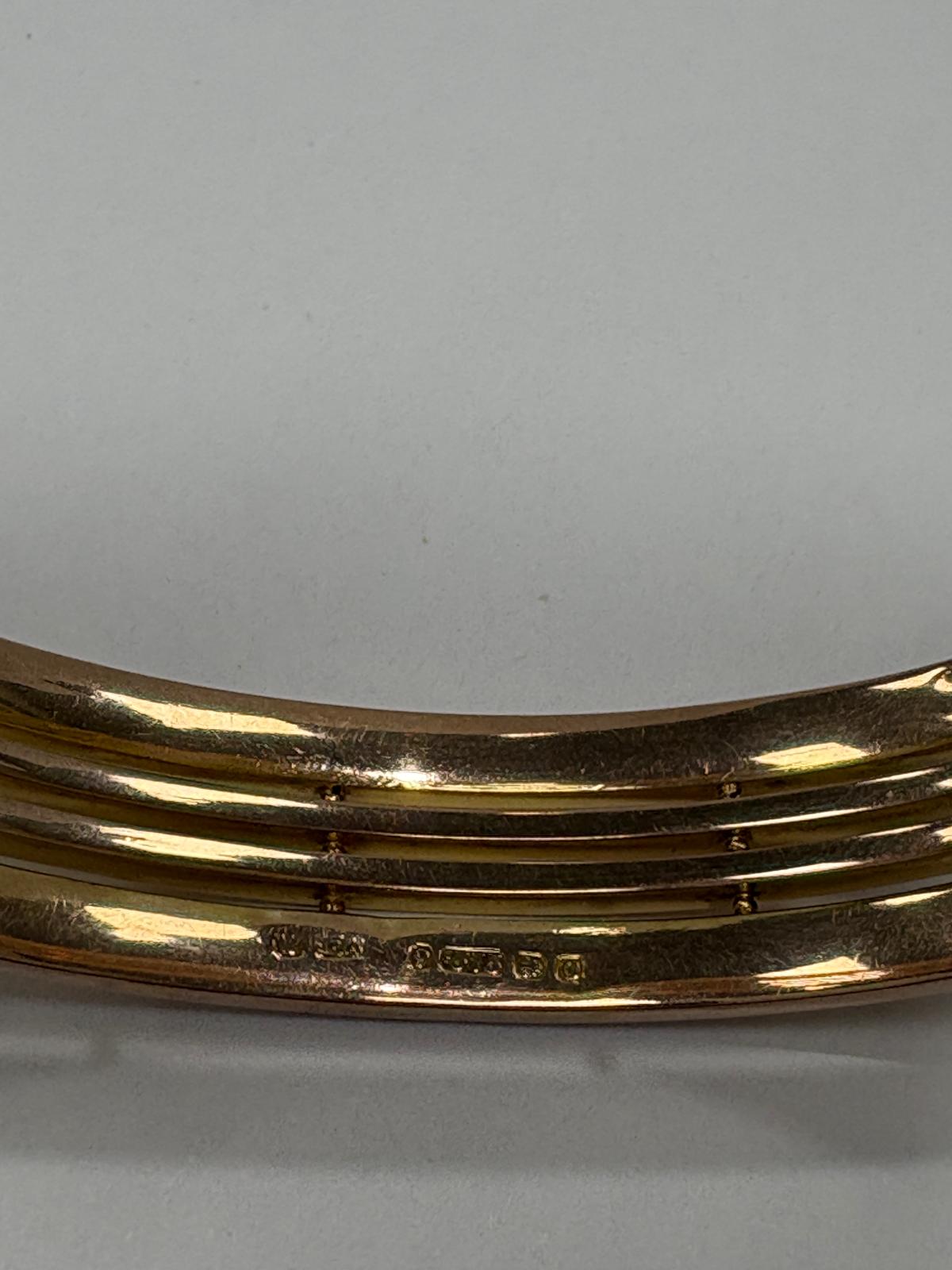 Close up of Birmingham 1964 hallmark on 9ct gold gate bangle