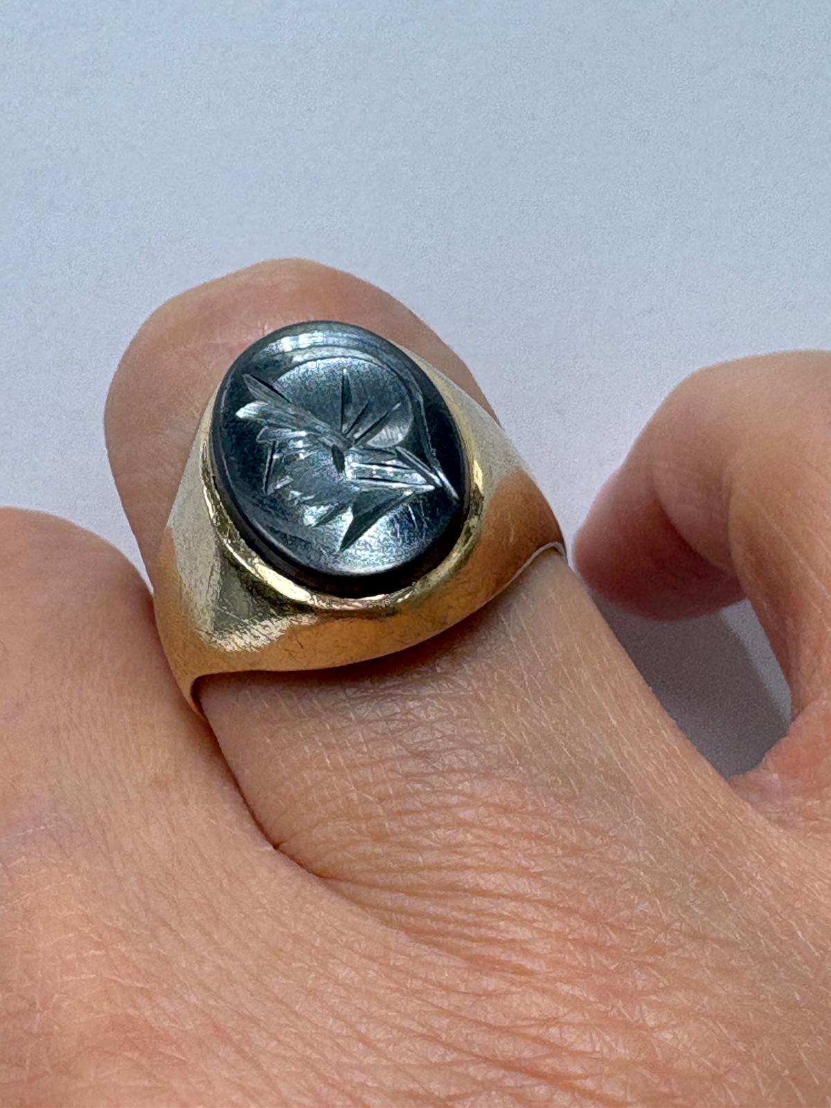 Signet ring displayed on ring cone, side angle, hematite intaglio visible