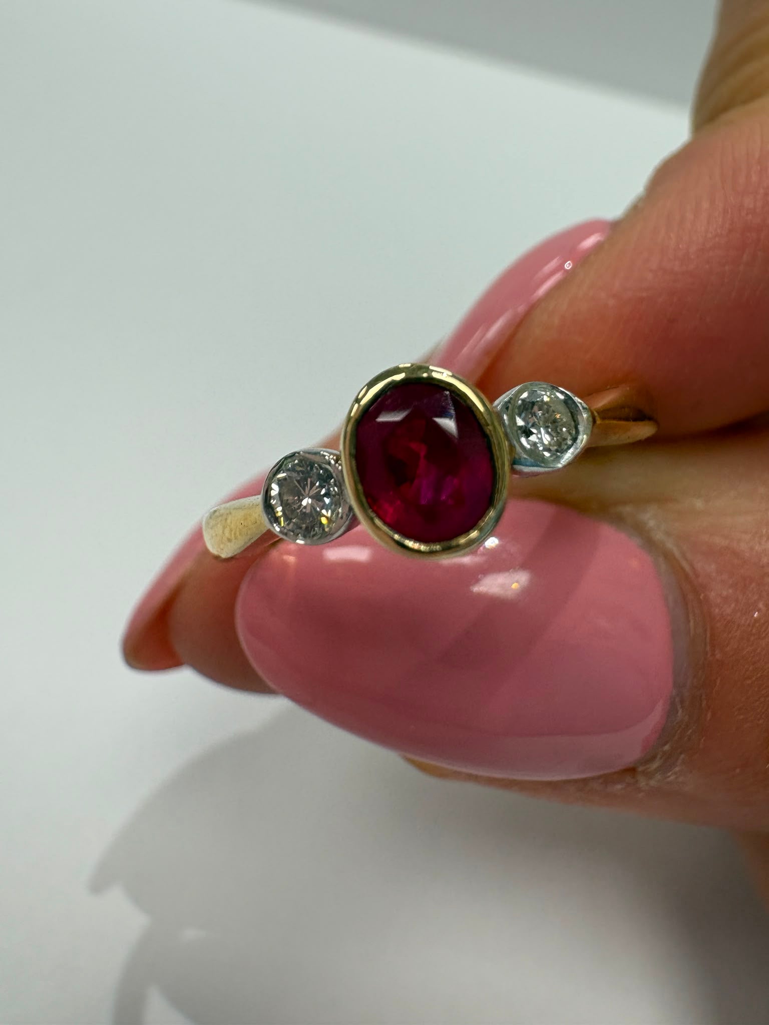 ruby and diamond ring, bezel set ruby ring, two tone gold ruby ring, second hand ruby ring UK, pre-loved three stone ring, vintage ruby diamond ring, 9ct gold ruby ring, ruby diamond trilogy ring, second hand jewellery Harrogate, second hand jewellery Leeds, second hand jewellery York, second hand jewellery Yorkshire, pre-owned ruby ring UK, bezel set gemstone ring, buy second hand ruby ring, ruby ring size N, ruby ring near me, fine jewellery Harrogate, pre-loved jewellery Yorkshire
