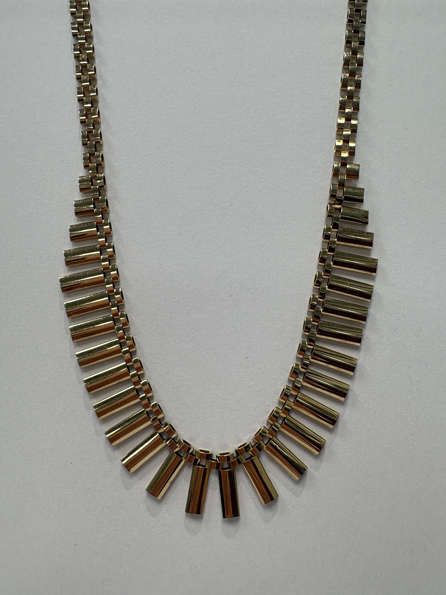 Vintage 1970s 9ct yellow gold graduating fringe necklace with alternating textured and polished cylindrical bars on a brick link chain with safety clasp, 20.50g, shown on white background, available at Fogal & Barnes Harrogate