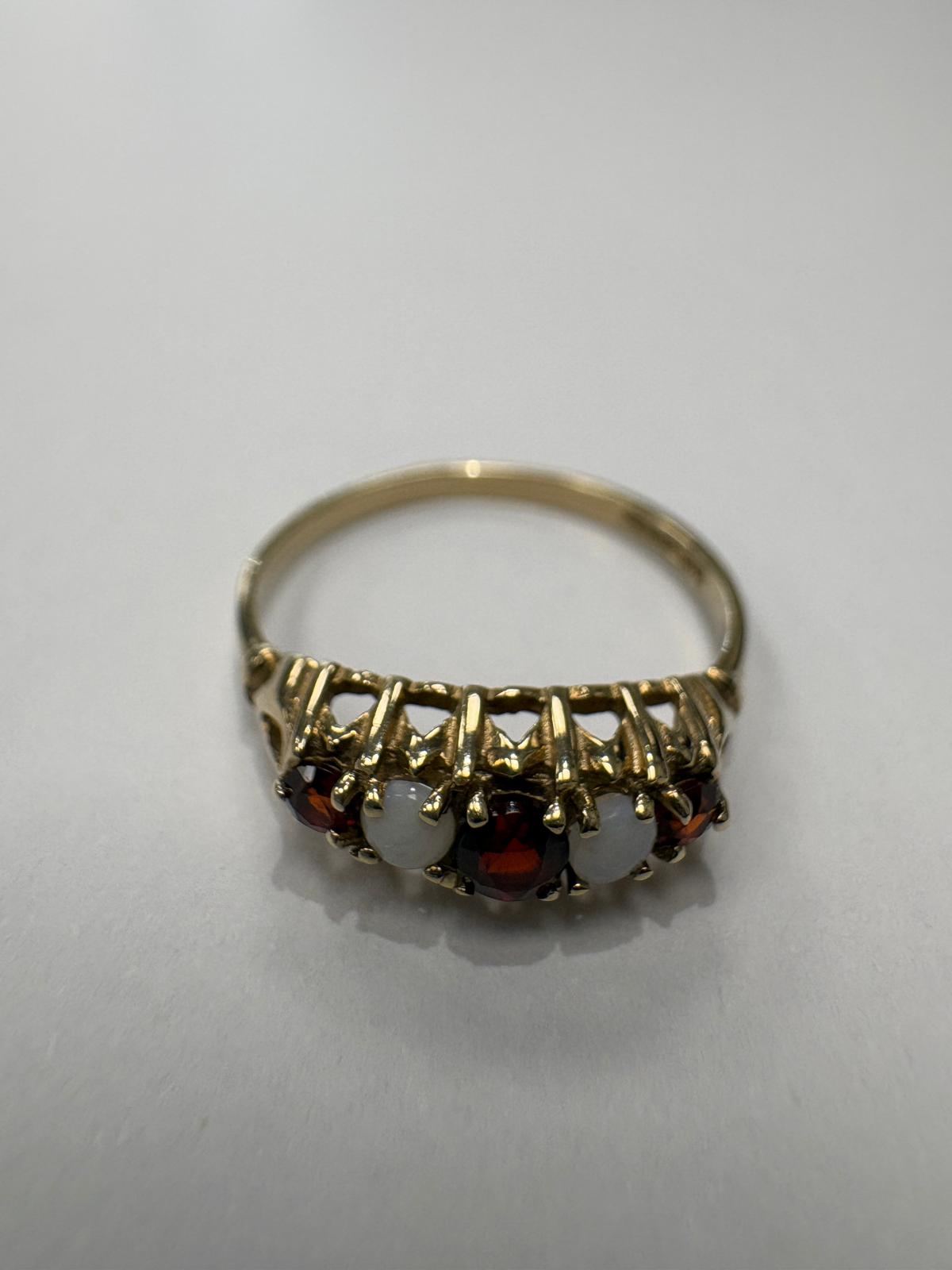 Garnet and opal five stone ring on the finger, size N½