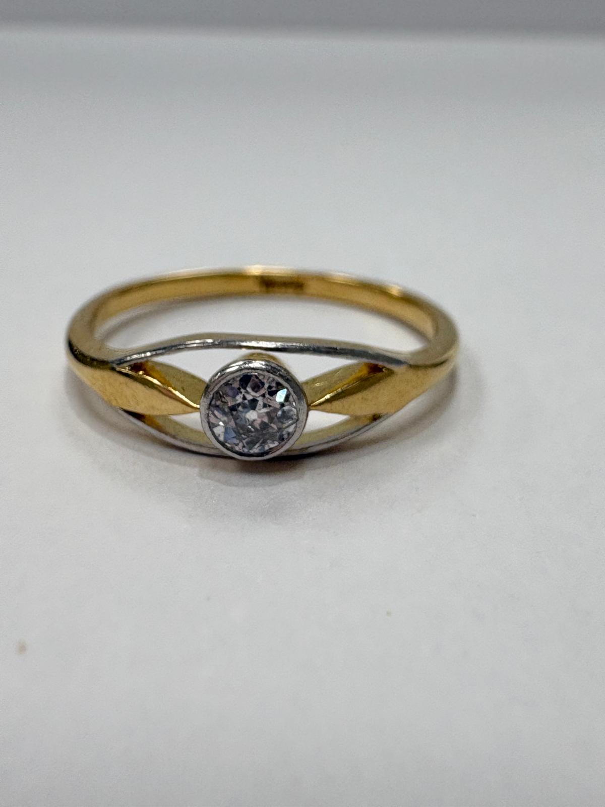 Vintage 9ct two tone yellow and white gold old cut diamond solitaire ring with open crossover shoulders, 0.15ct diamond, size N½, shown on ring cone and close up on white background, available at Fogal & Barnes Harrogate