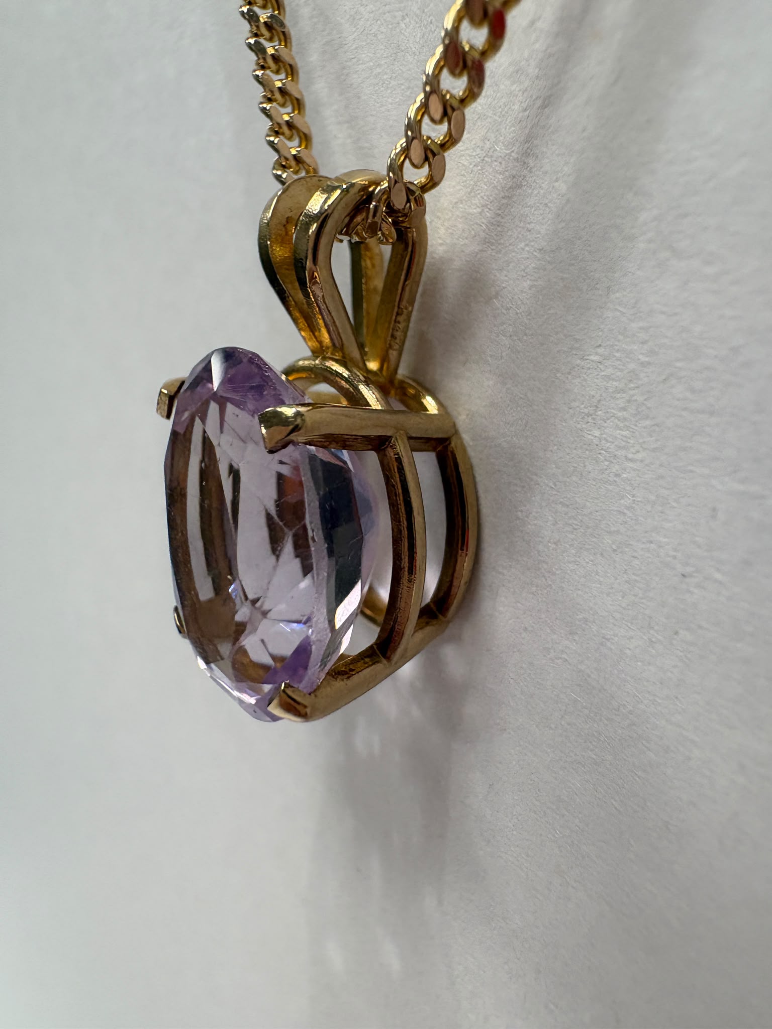 Natural 4.5ct oval amethyst pendant in 14ct gold, with 9ct gold curb chain, 20 inches, 13.27g total. Sold together or separately. Fogal & Barnes, Harrogate.