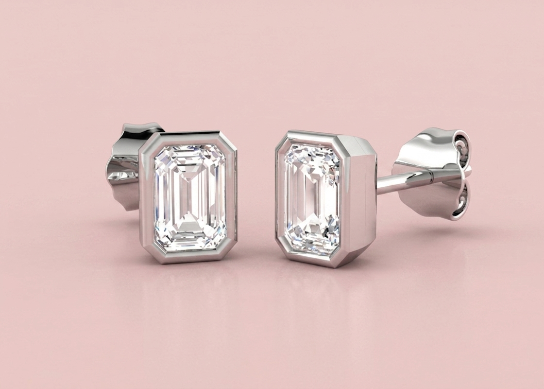 Bezel set lab grown emerald cut diamond stud earrings shown in white gold, 1.11ct 