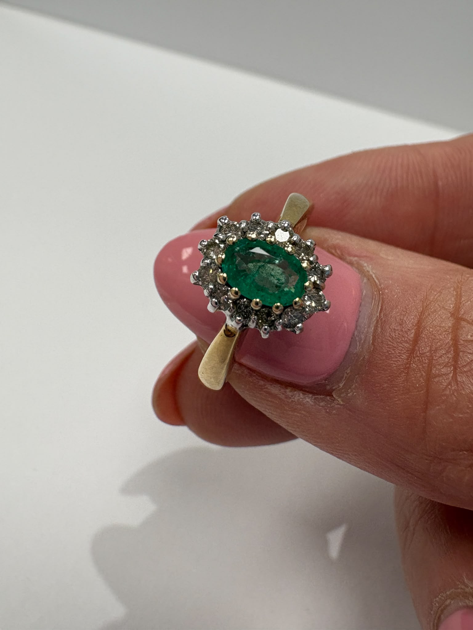 emerald and diamond ring, emerald cluster ring, second hand emerald ring UK, pre-loved emerald ring, vintage emerald ring, 9ct gold emerald ring, oval emerald ring, May birthstone ring, second hand jewellery Harrogate, second hand jewellery Leeds, second hand jewellery York, second hand jewellery Yorkshire, pre-owned emerald ring UK, antique style emerald ring, classic emerald cluster ring, buy second hand emerald ring, emerald ring size N, emerald ring near me, fine jewellery Harrogate, pre-loved jewellery