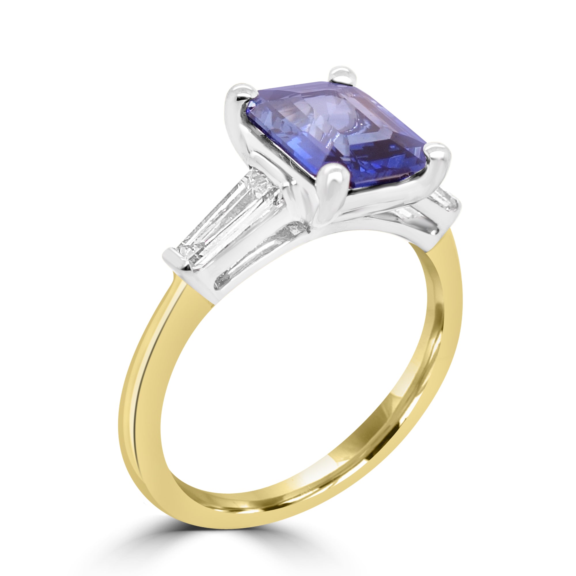 Emerald cut sapphire and diamond three stone engagement ring set on 18k yellow gold from fogal and barnes fine jewellers of Harrogate 