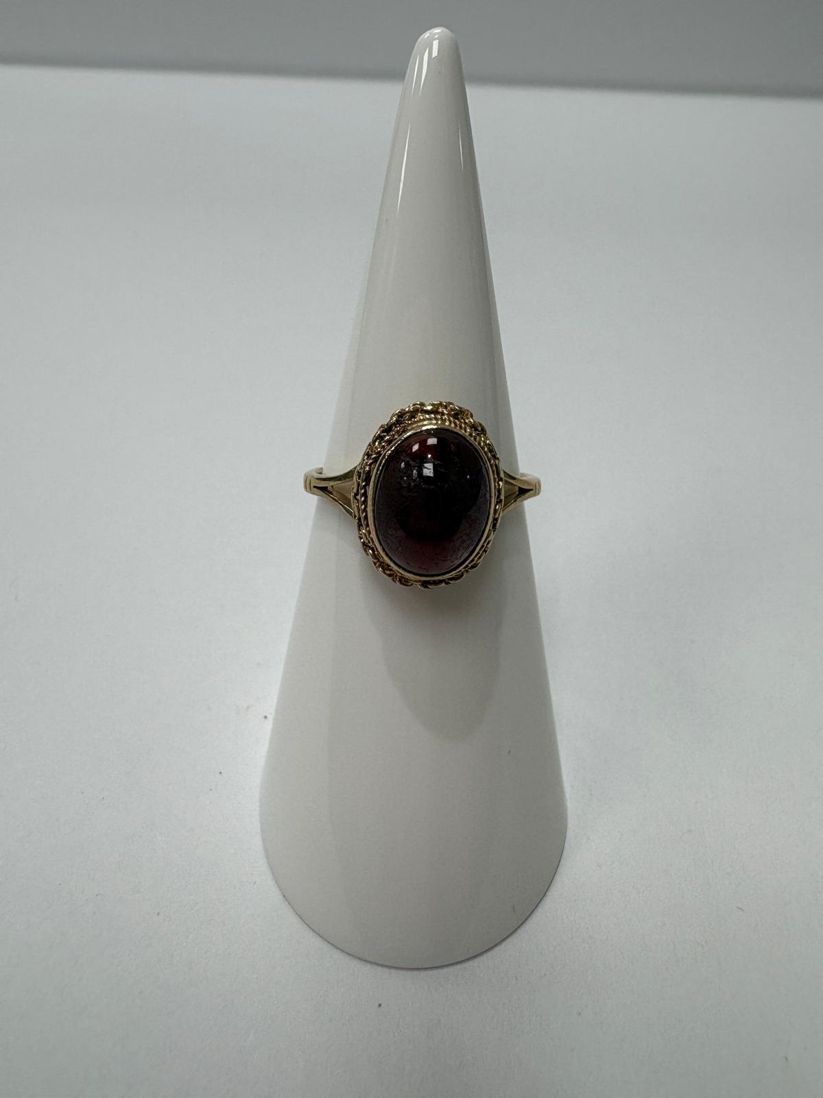 9ct gold vintage garnet ring on display stand, front facing