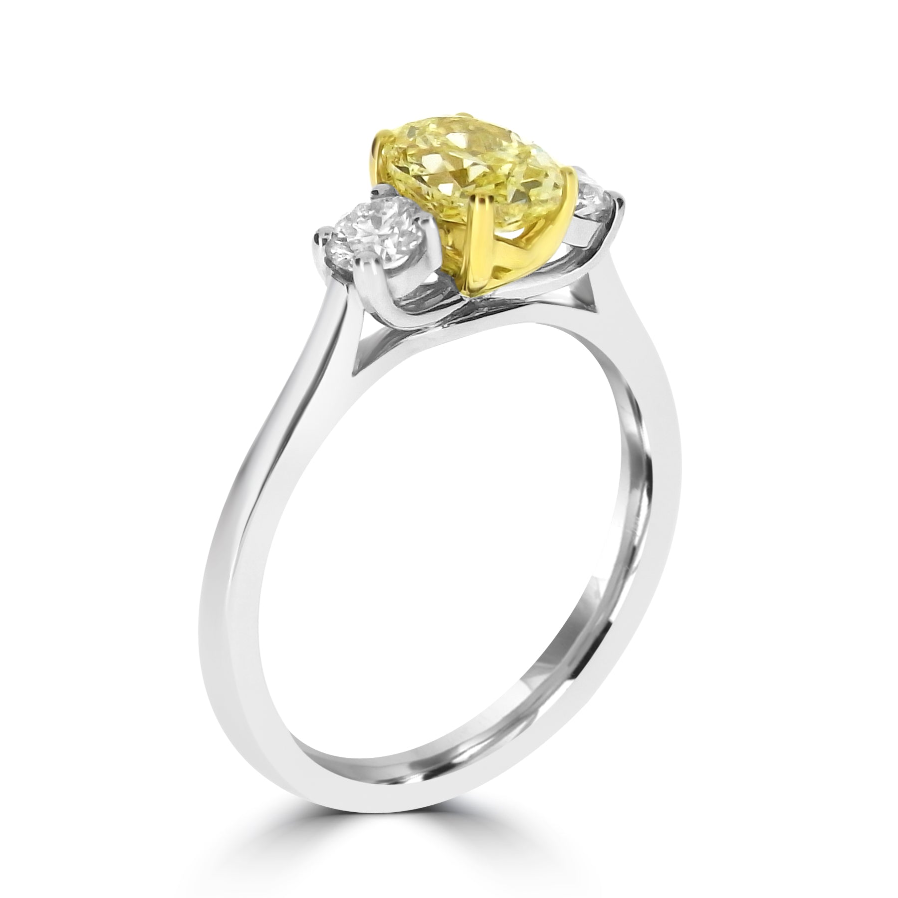 Close-up of fancy yellow oval diamond in yellow gold setting harrogate 