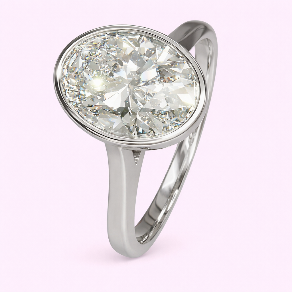 Raye 2.50ct oval lab grown diamond bezel engagement ring in yellow gold by Fogal and Barnes Harrogate