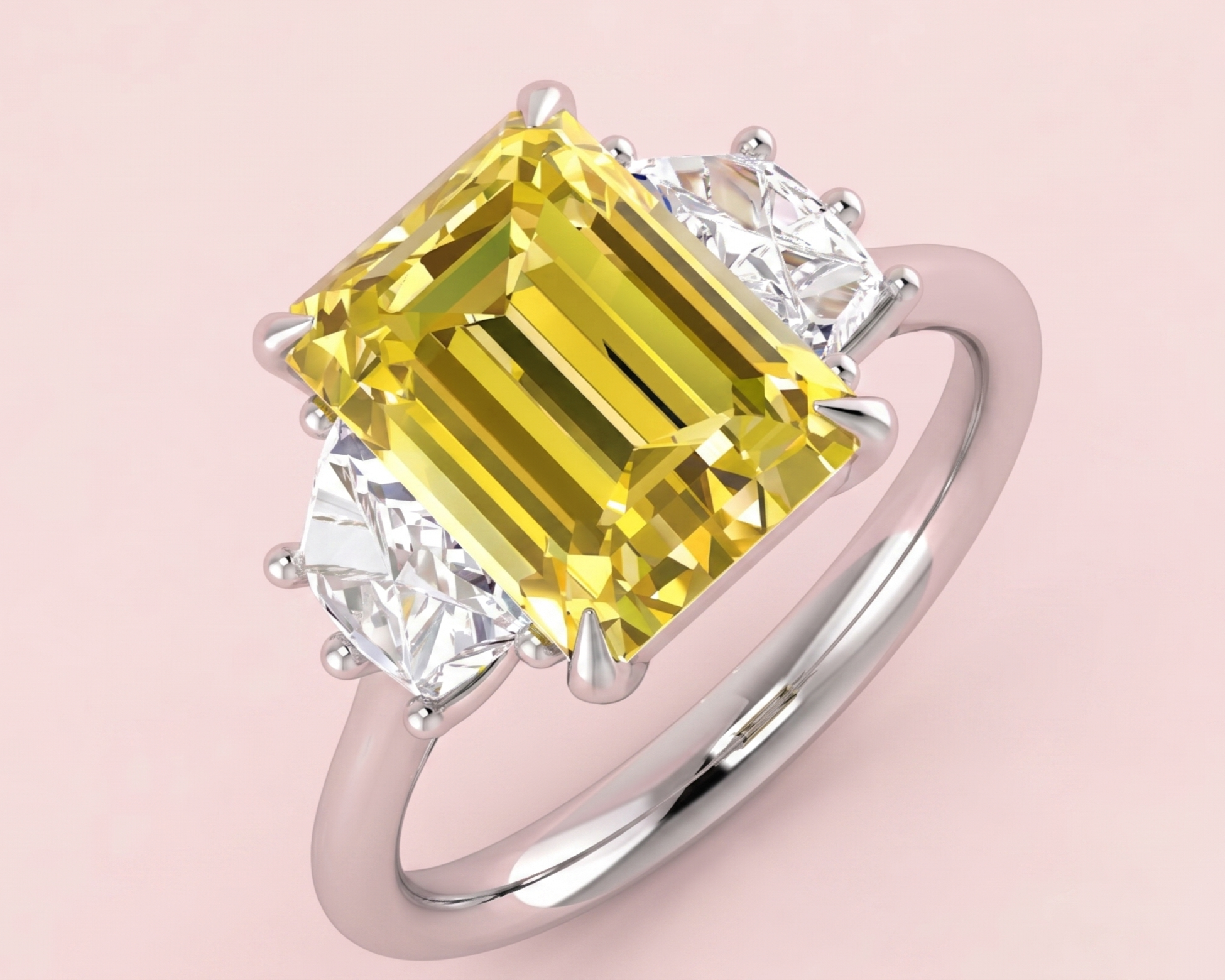 Lab grown yellow diamond three stone ring featuring a 3.56ct radiant cut centre stone flanked by two cadillac cut white diamonds totalling 0.82ct, shown in white gold on pink background