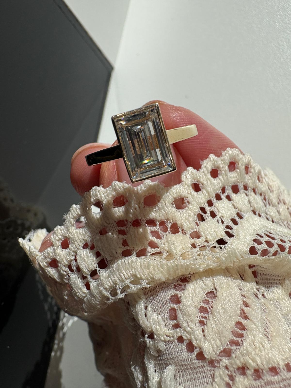 Lab-grown diamond emerald cut yellow gold bezel set ring from Fogal and Barnes Harrogate 