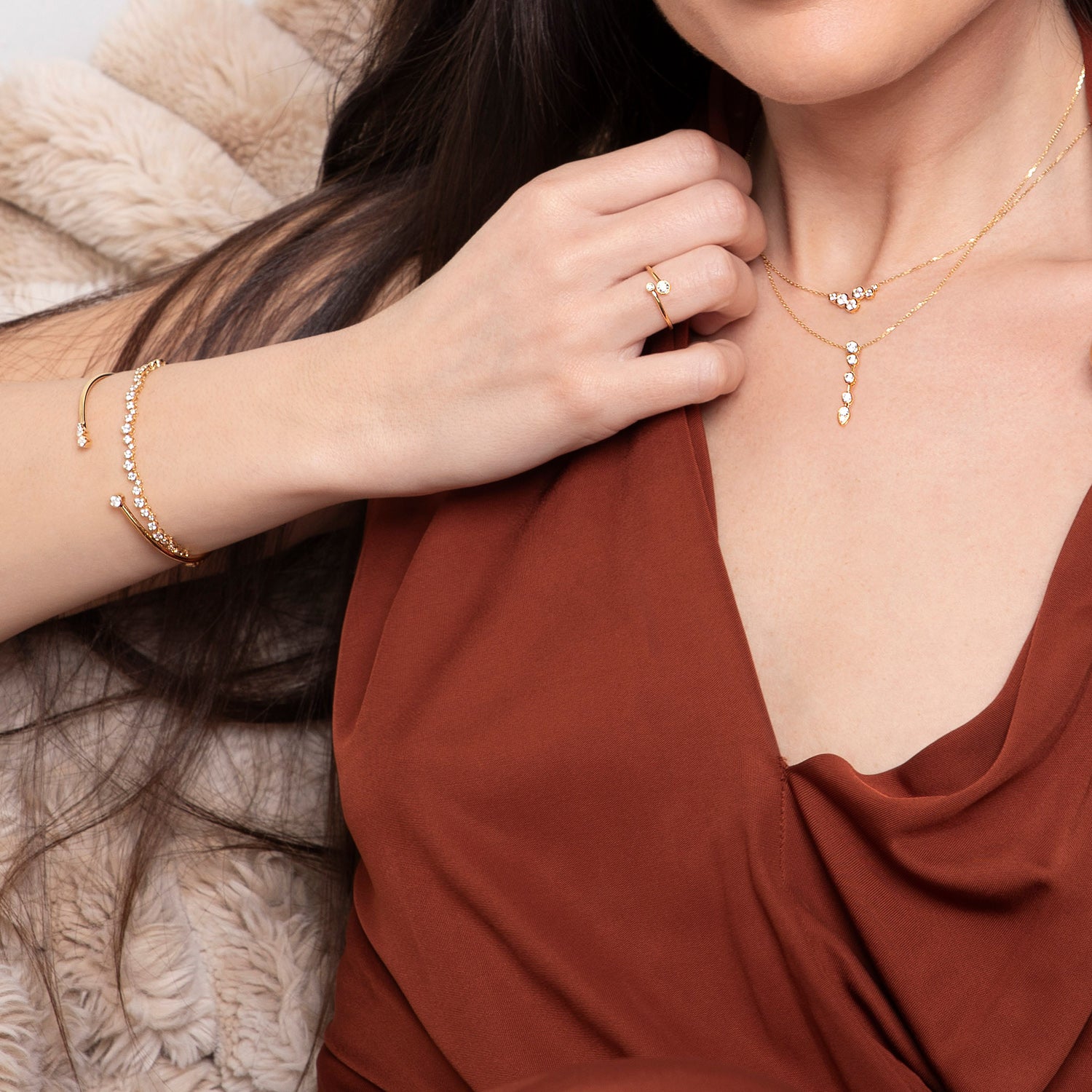 Yellow gold bezel set diamond drop pendant necklace featuring five graduating diamonds, shown on model