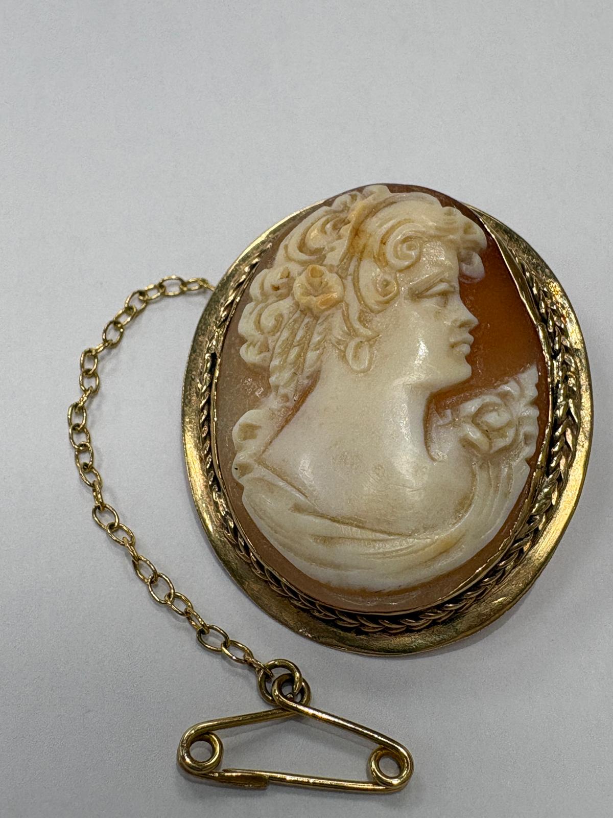 Reverse of Victorian 9ct gold cameo brooch showing original gold pin fitting with safety chain and secondary clasp