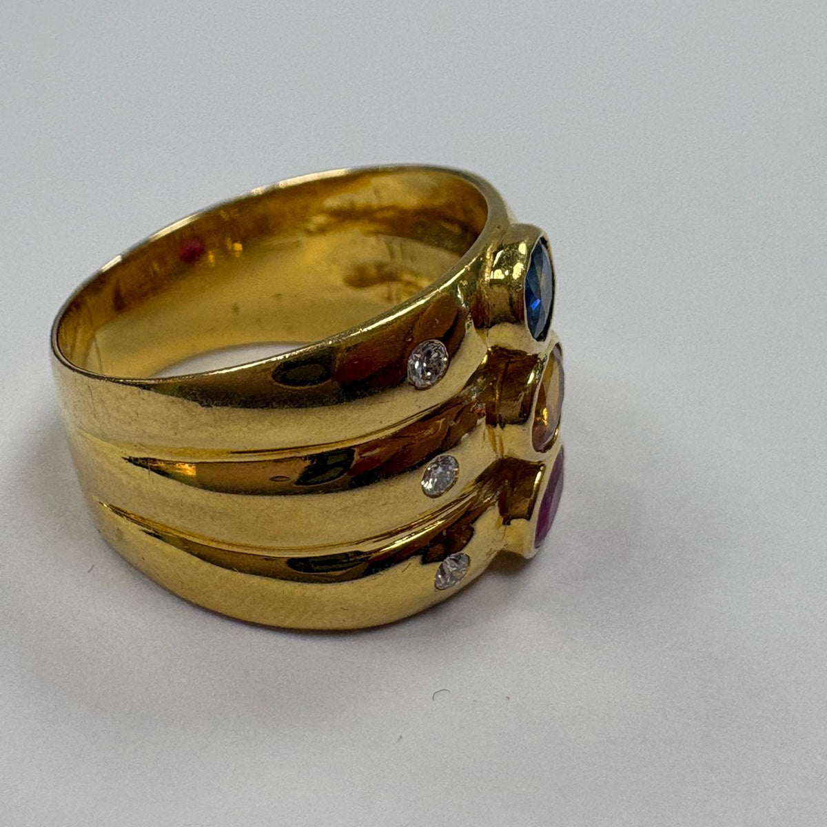 multi gem ring, ruby sapphire citrine ring, 18ct gold statement ring, triple band ring UK, wide gold gemstone ring, cocktail ring gold, pre-loved gemstone ring, birthstone family ring