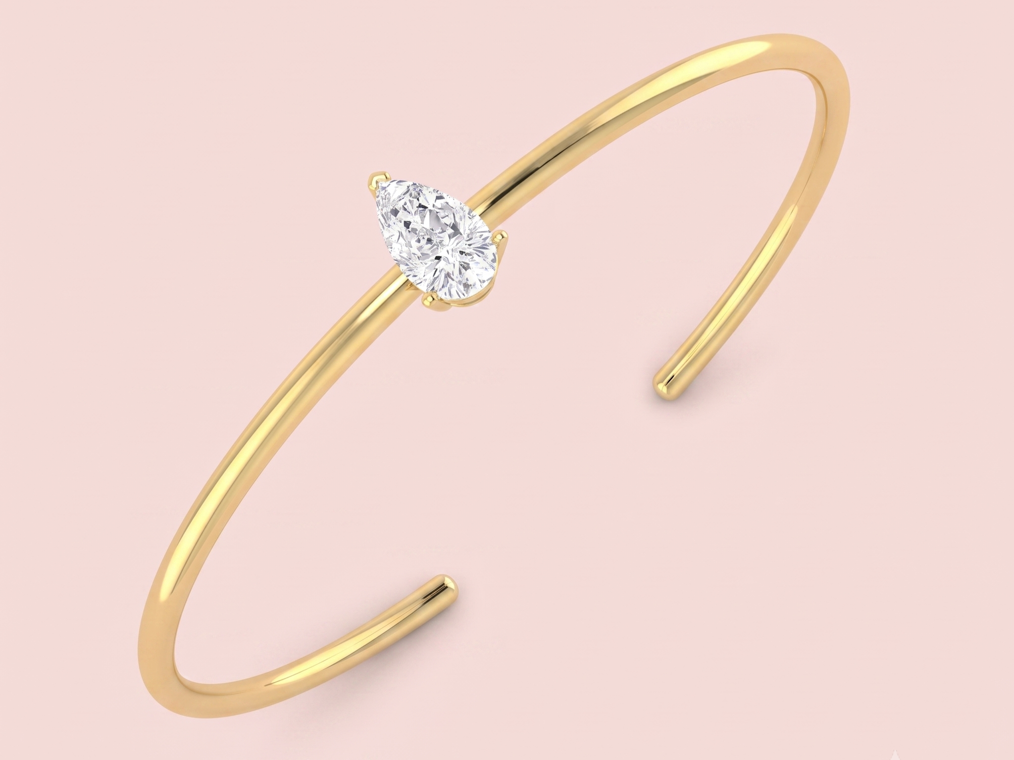 A gold open cuff bracelet featuring a single pear-cut diamond in a prong setting, shown against a solid pale pink background.