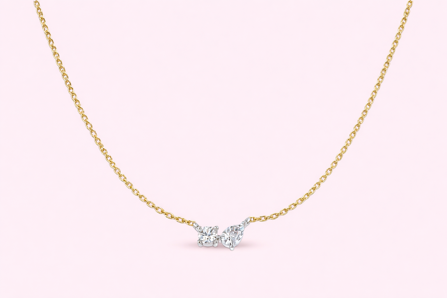 Two stone lab-grown diamond pendant with pear and round diamonds in yellow and white gold, Fogal and Barnes Harrogate UK
