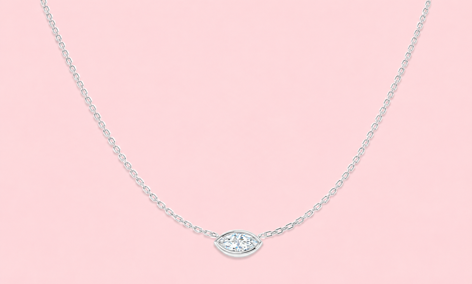 Bezel set lab grown marquise diamond solitaire necklace shown in yellow gold and white gold on a pink background, 0.57ct single stone pendant