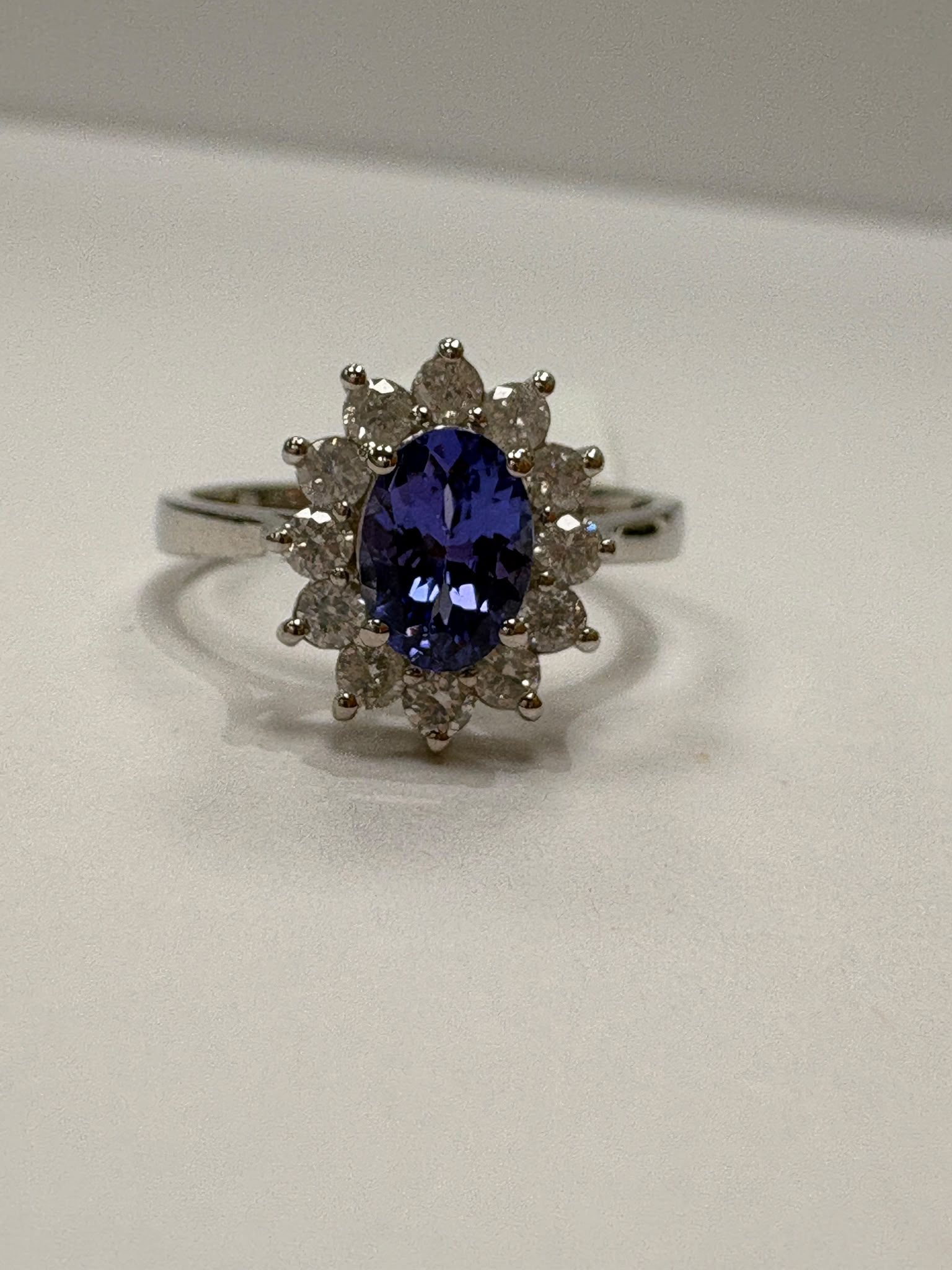 Tanzanite and diamond cluster ring in 9ct white gold, oval tanzanite centre stone