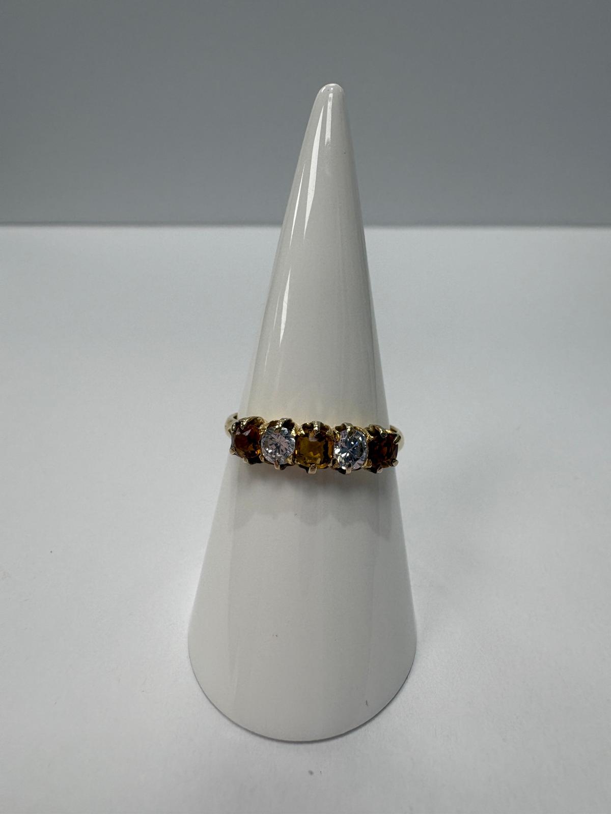 Vintage 18ct yellow gold citrine and white stone five stone graduating ring size S½ with three amber citrines alternating with two white stones in claw setting, shown on white background and worn on finger, available at Fogal & Barnes Harrogate
