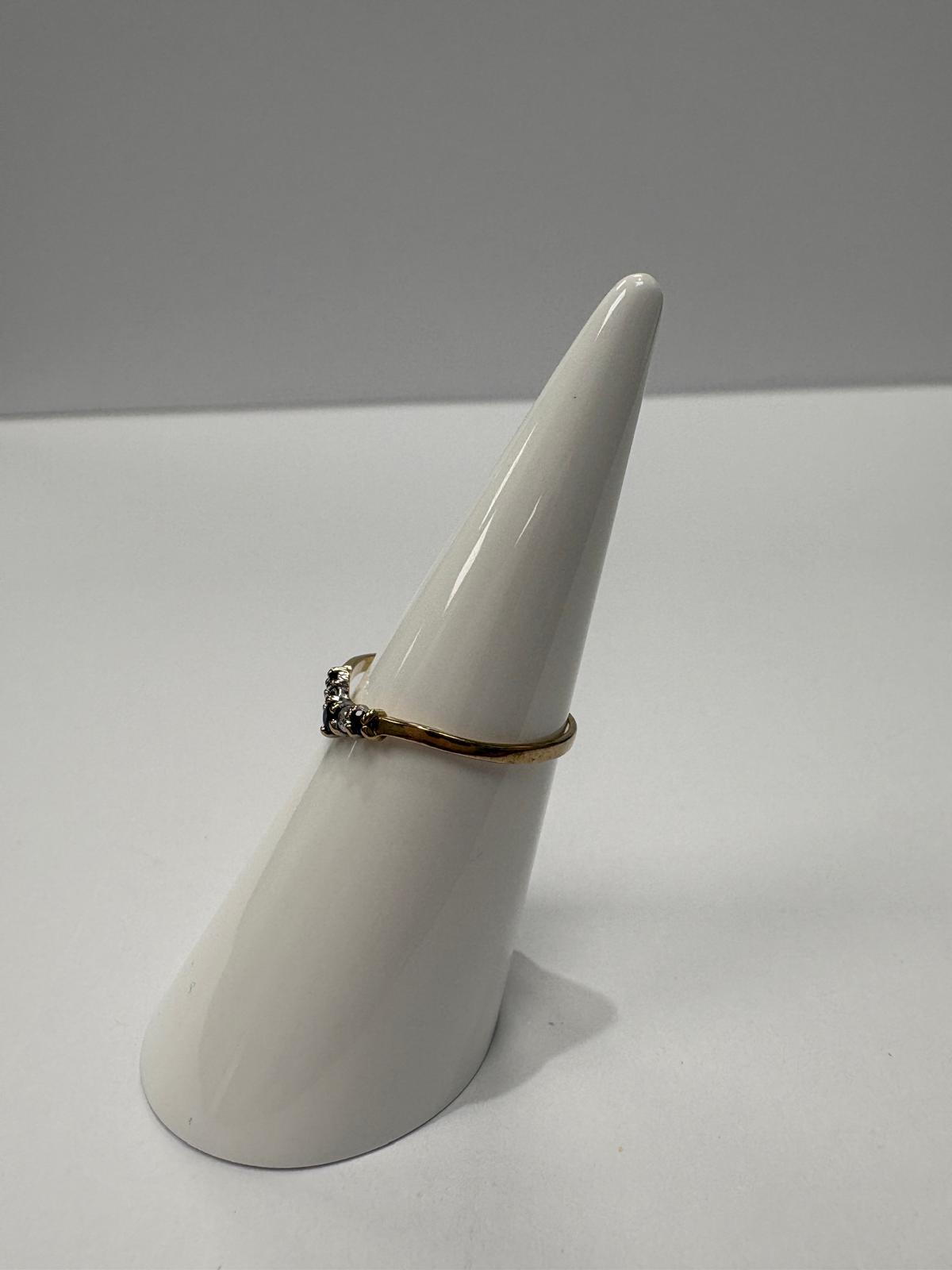 Vintage 9ct yellow gold sapphire and cubic zirconia wishbone ring size K½ with alternating blue sapphire and white CZ stones in V shape setting, shown on ring cone and close up on white background, available at Fogal & Barnes Harrogate