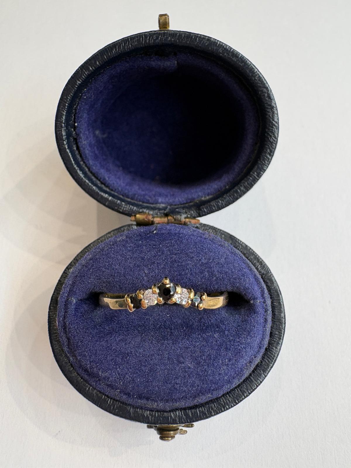 A wishbone gold ring with sapphires and CZ in a vintage velvet box