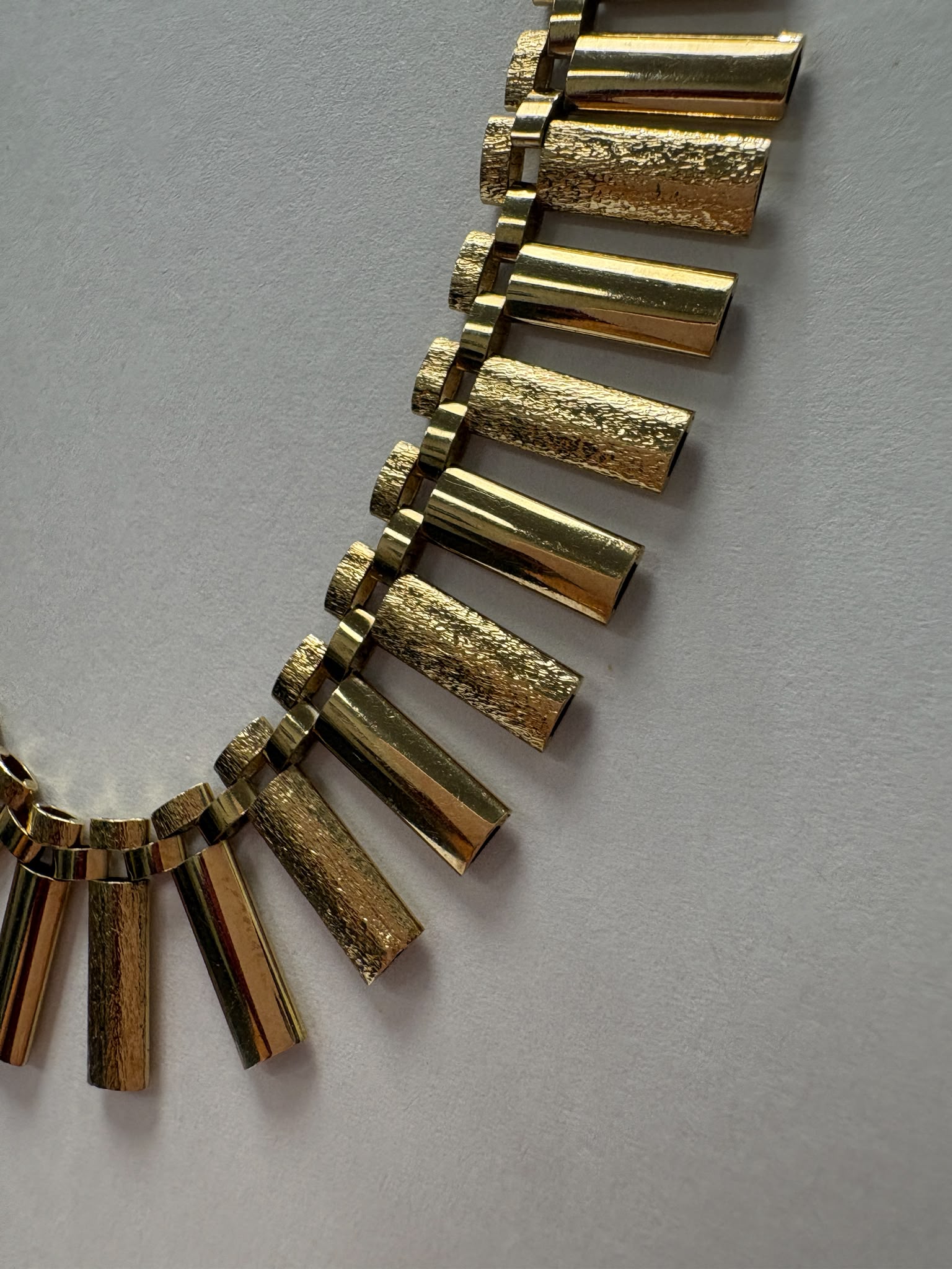 Vintage 1970s 9ct yellow gold graduating fringe necklace with alternating textured and polished cylindrical bars on a brick link chain with safety clasp, 20.50g, shown on white background, available at Fogal & Barnes Harrogate
