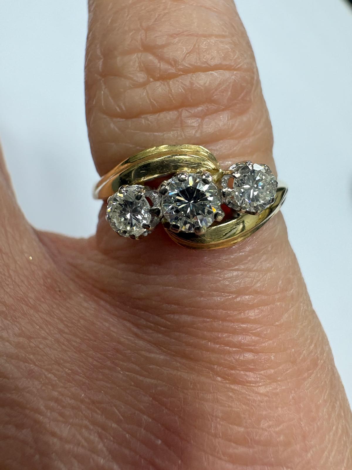 Antique Victorian 18ct yellow gold three-stone diamond bypass ring shown on hand, size K