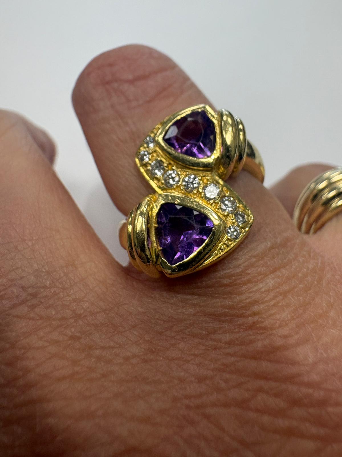 Pre-loved 18ct yellow gold toi et moi ring with two trilliant-cut natural amethysts and diamond bridges, size N