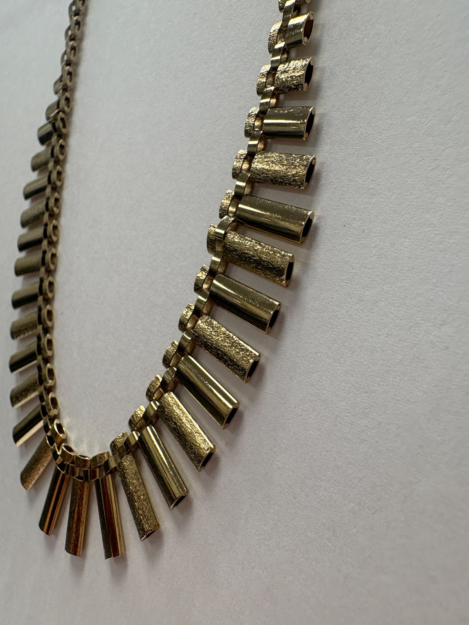 Vintage 1970s 9ct yellow gold graduating fringe necklace with alternating textured and polished cylindrical bars on a brick link chain with safety clasp, 20.50g, shown on white background, available at Fogal & Barnes Harrogate