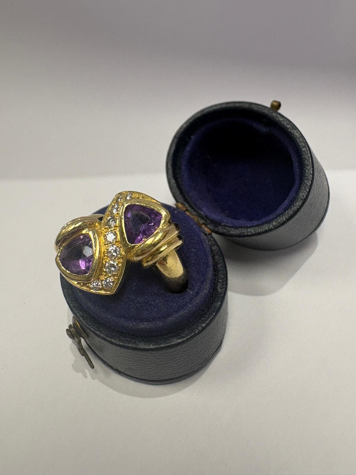 Profile view of pre-loved 18ct gold amethyst and diamond toi et moi ring on reeded shank, size N