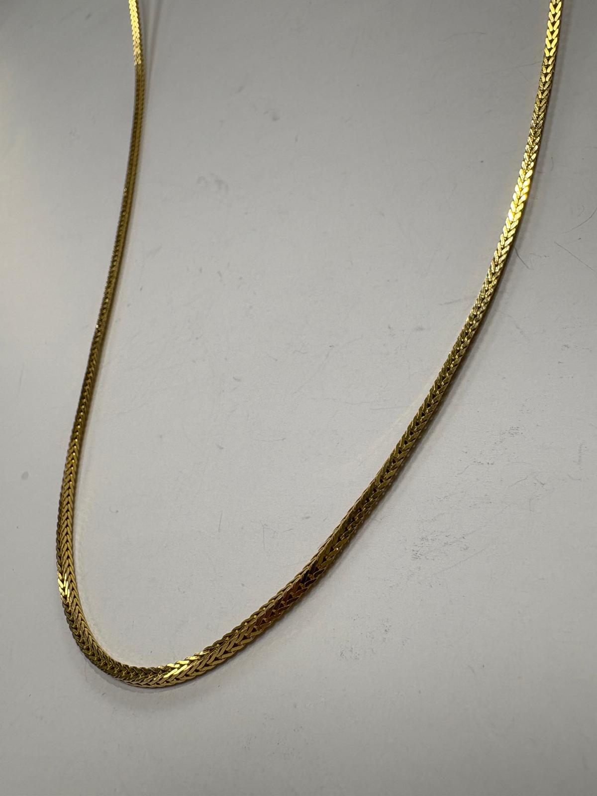 Close-up detail of pre-loved 18ct yellow gold foxtail chain V-link weave pattern