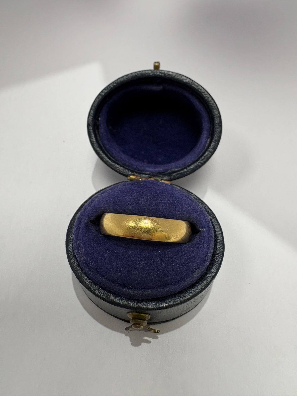 Pre-loved 18ct yellow gold wide plain court wedding band shown on hand, size J