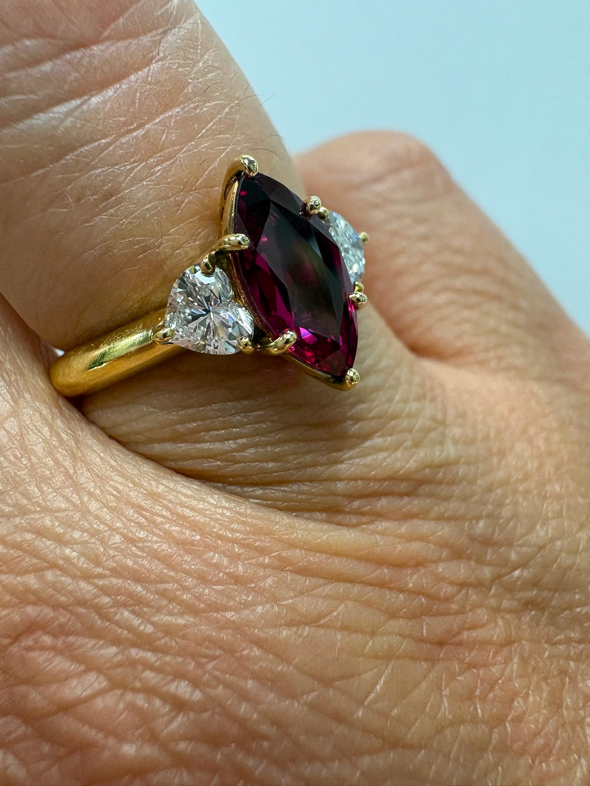 pre-loved ruby ring, second hand 18ct gold ring UK, GIA certified ruby ring, three stone ruby diamond ring, marquise ruby ring, pre-owned fine jewellery UK, heart diamond ring, second hand fine jewellery UK, certified ruby engagement ring