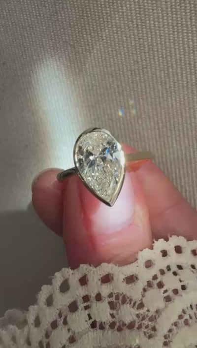 pear cut lab grown diamond engagement ring bezel set yellow gold band harrogate jewellers 