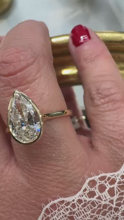 Yellow gold pear shape bezel set lab-grown diamond engagement ring in Harrogate Jewellers Fogal and Barnes 